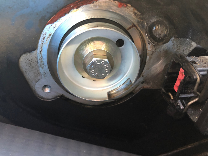 This is the cam-side of the hall sensor, a cup with an opening to trip the magnet on the other side.
